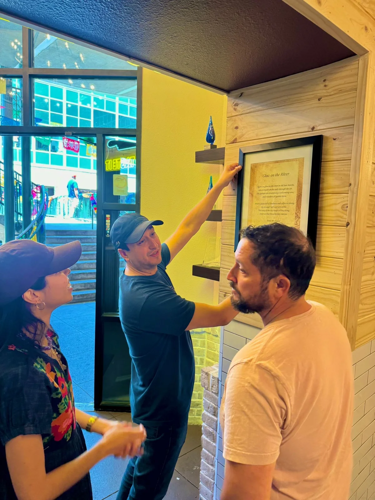 John Vale placing Ennis M. Salam's poem at Alamo Biscuit Co. and Panaderia